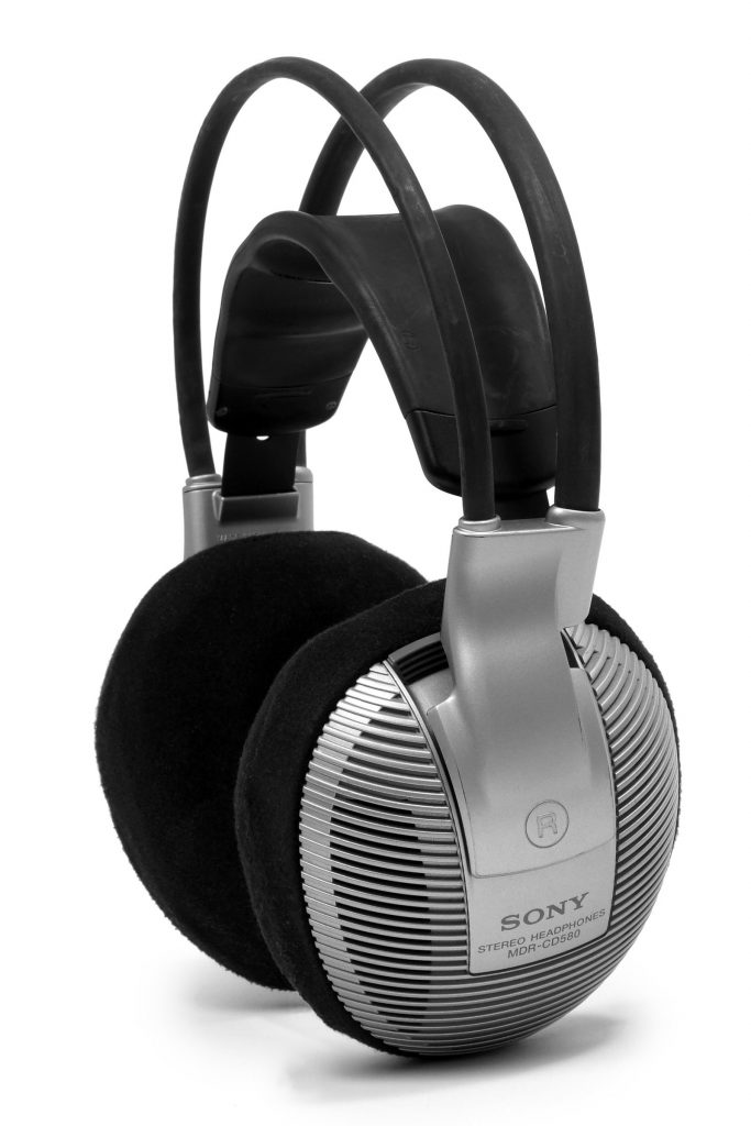 Pair of over-ear Sony headphones on a plain background